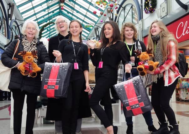 Adele Wilson and Rebecca Medhurst from The Perfume Shop with some happy shoppers help promote the up and coming Black Friday event at Priory Meadow Shopping Centre. Picture by: TONY COOMBES. SUS-161115-162529001