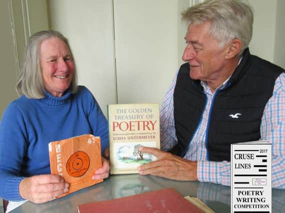 Belinda Wilkins shows Michael Spike Milligan the items that sparked her Cruse Lines Poetry Writing Competition