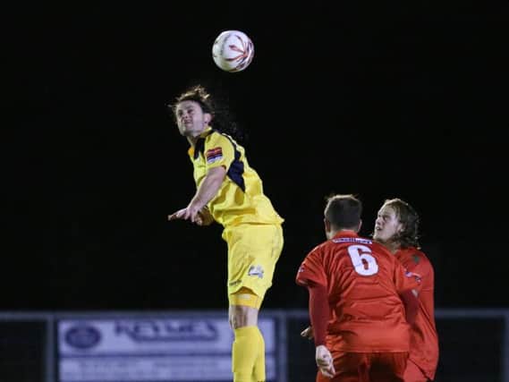 Hastings United forward Frannie Collin wins a header against South Park on Wednesday night. Picture courtesy Scott White