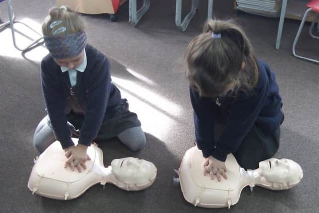 Year two children practise an element of CPR