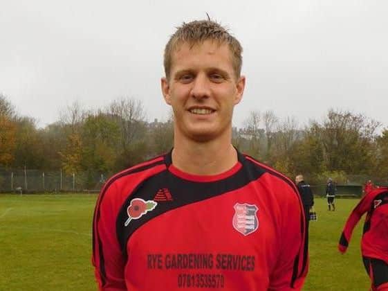 Luke Willis wearing Rye Town's special Remembrance weekend shirts adorned with a Poppy symbol.