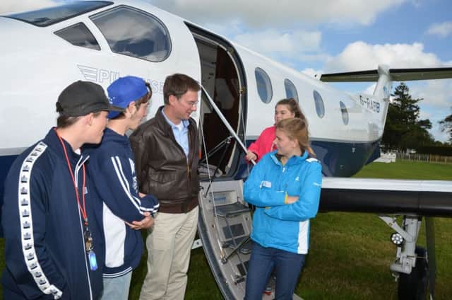 Pilot Edwin Brenninkmeyer talks with St Anthonys School students by the new Pilatus PC-12NG executive aircraft