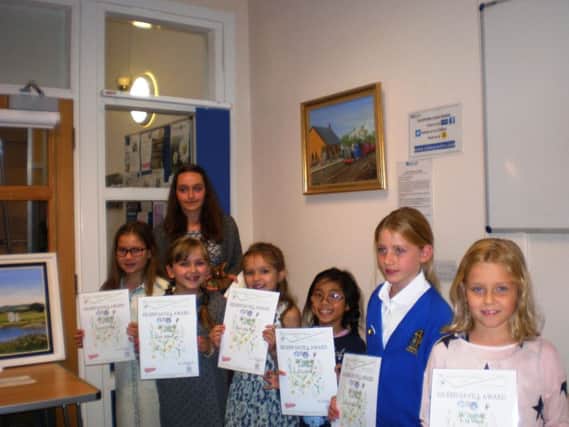 The seven prize winners with their drawings and painting