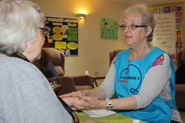 St Catherine's Hospice Patient Myra having hand massage by volunteer, Pat Birnie (photo submitted).