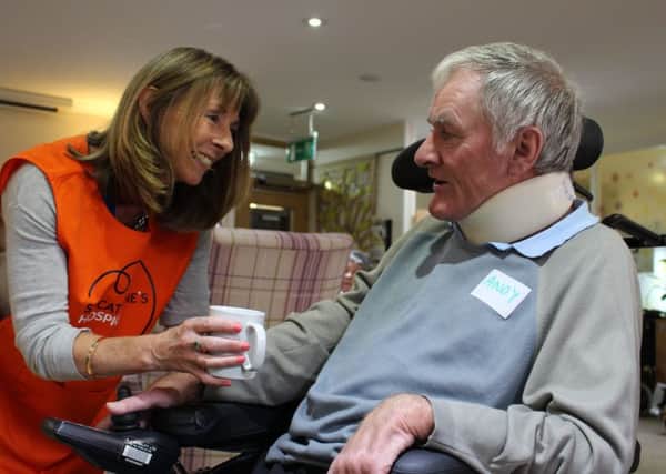 St Catherine's Hospice Volunteer Pam Williams in new orange tabard with patient, Andy (photo submitted).