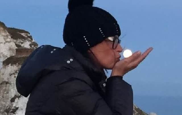 This photograph sent in by Martin Gratz shows his wife Christina with the supermoon at Beachy Head
