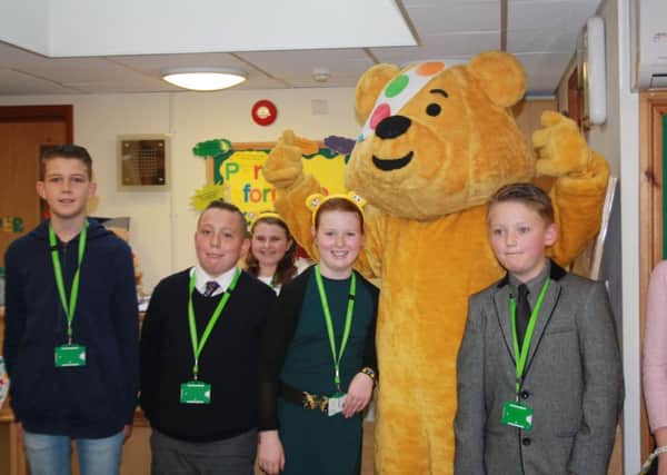 Takeover day pupils from Little Common school with BBC Children in Need mascot Pudsey Bear SUS-161123-162106001