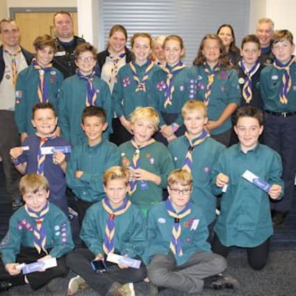 The scouts pictured with PCSOs at Hammonds Drive police station SUS-161121-164607001