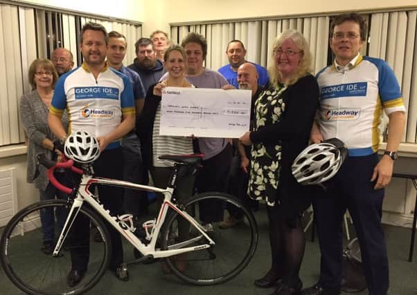 George Ide solicitors present their cheque for Â£7,500 to HWS representatives