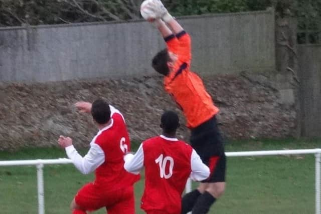 Bexhill goalkeeper Dan Rose safely gathers an aerial ball. Picture courtesy Mark Killy
