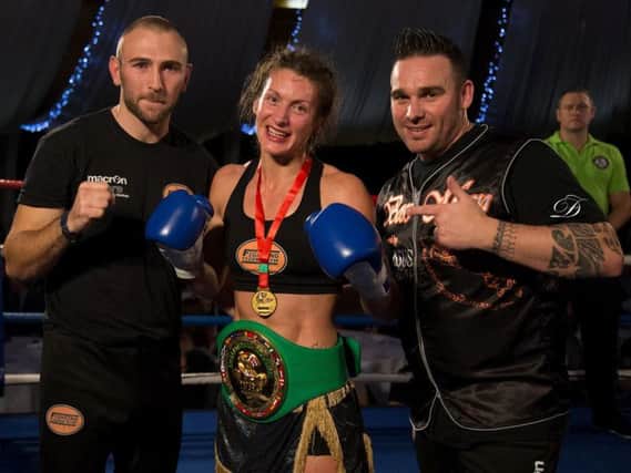Amy Campbell proudly wears her title belt alongside Jimmy Killick (left) and Andy Chambers. Picture courtesy DaveFordArt