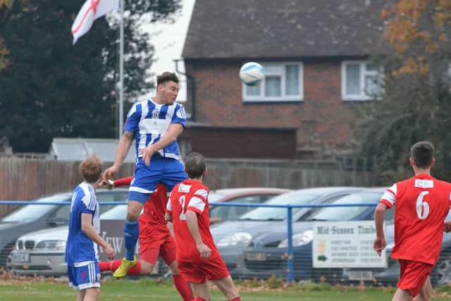 Nathan Cooper shows his ariel strength. Haywards Heath Town v Horsham YMCA. Picture by Grahame Lehkyj