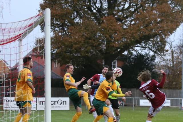 Horsham v Hastings United football action - Harry Stannard (claret number six) hits a shot which is cleared off the line SUS-161127-210146002