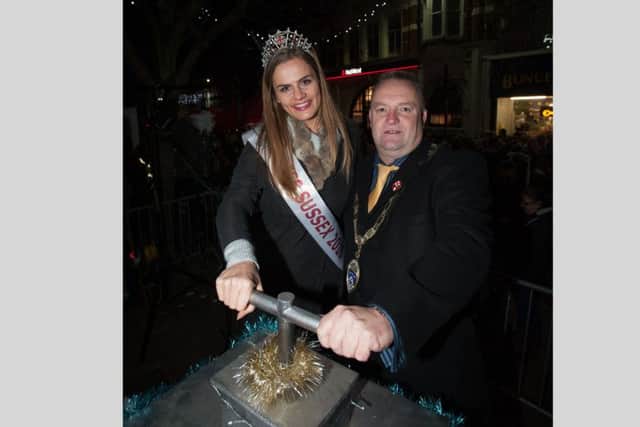 Miss Sussex, Victoria Smart and town mayor, councillor Ian Buckland, turn on this year's Christmas lights. Picture: Scott Ramsey