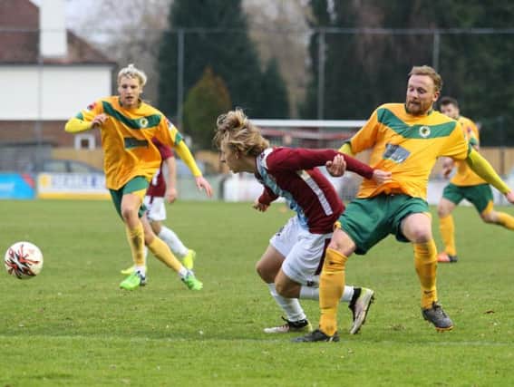 Hastings United attacking player Harry Stannard seeks to escape the clutches of a Horsham defender on Saturday. Picture courtesy Scott White