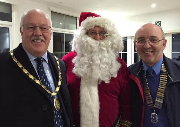 Chichester Lions Club president Richard Cowell, right, and Chichester deputy mayor Peter Evans with Father Christmas ku783pSrbfg_nJYepnXS