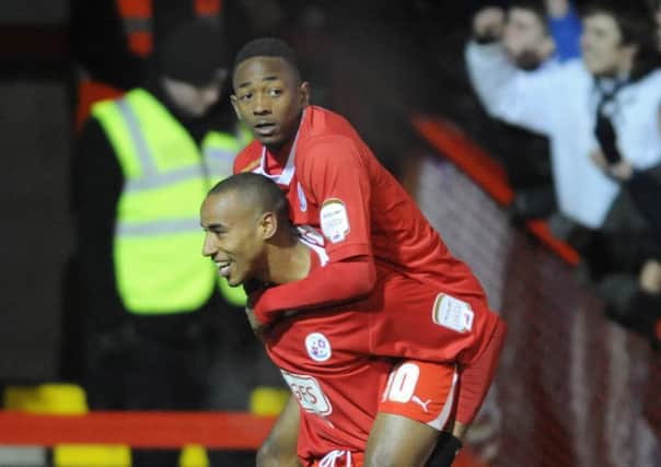 Sanchez Watt catches a lift from Tyrone Barnett during his former spell at Crawley Town