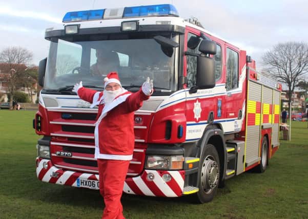Worthing town crier Bob Smytherman was dressed as Father Christmas and arrived on a fire engine