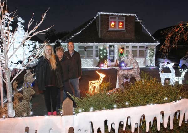 DM16155723a.jpg The King family, L to R, Carrina, Sallyanne and Grahame, outside their house in Horsham decorated for the Make a Wish Foundation. Photo by Derek Martin SUS-161129-183715008