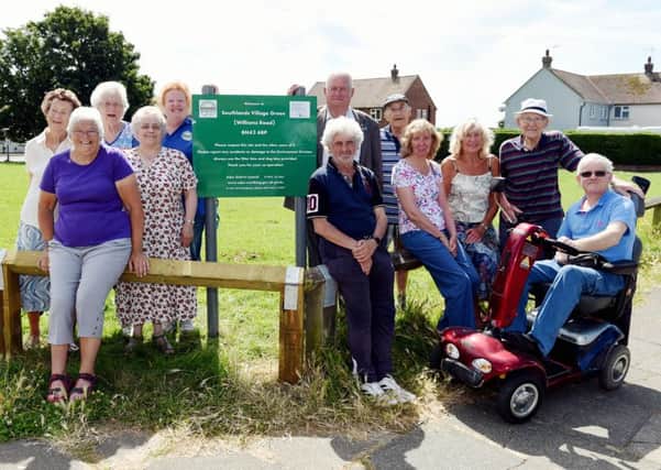 Unveiling the  Southlands Village Green sign in July, Southlanders Community Group chairman Ann Martin and Adur councillor Paul Graysmark, watched by residents from the Williams Road area. Picture: Liz Pearce LP1600219