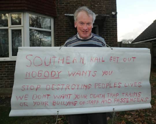 Michael Dyer with his one man rail protest placard (Photo by Jon Rigby) SUS-161123-082507008
