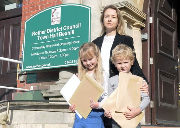 Helen Eckersley handed a petition calling for the Street Farm decision to be overturned to Rother District Council with her children Lily and Daniel. Photo by James Eckersley SUS-161027-132845001