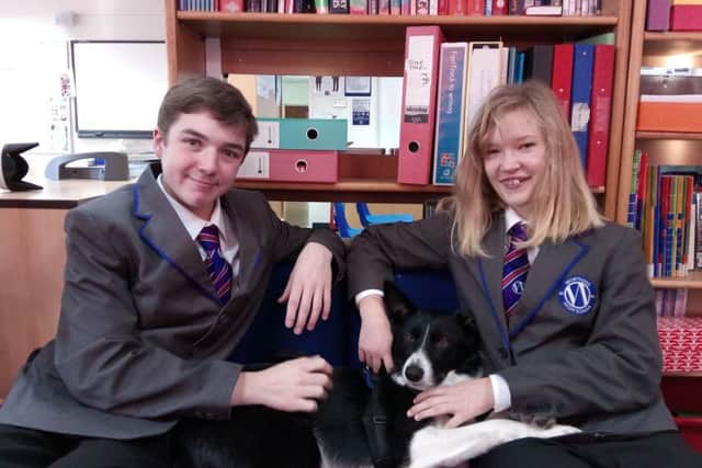 Max Older and Anastasia Clark, both 15, with Buddy the Worthing High School dog