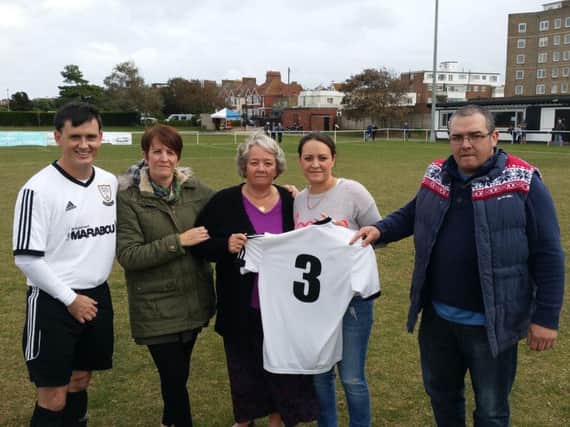 Members of Dickie Anderson's family and Bexhill United full-back Craig Ottley with the number three shirt which the football club has retired for the season. Picture courtesy Mark Killy
