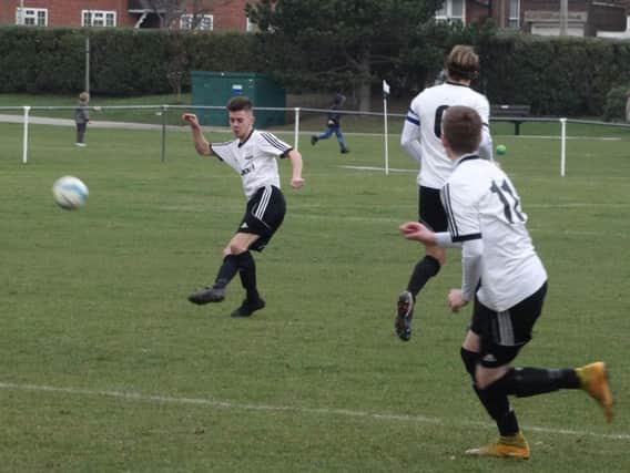 Kyle Holden thumps the ball downfield during Bexhill United's 1-0 win at home to Ringmer last weekend. Picture courtesy Mark Killy