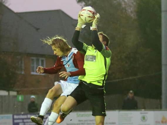Harry Stannard challenges Horsham goalkeeper Josh Pelling during last weekend's 1-1 draw. Picture courtesy Scott White