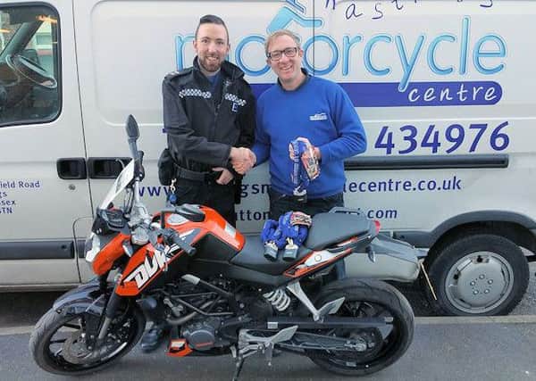 Police Community Support Officer Ryan Welby with Billy Sutton, of Hastings Motorcycle Centre. Picture courtesy of Sussex Police