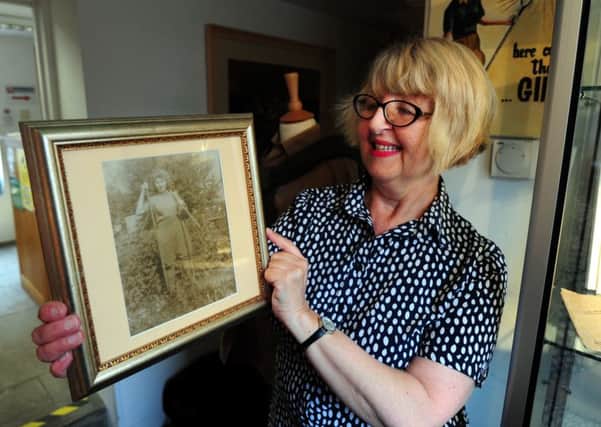 Julie Covey, administrative assistant at Rustington Museum, with a photo of her mother, who served in the Womens Land Army - ks16001196-3