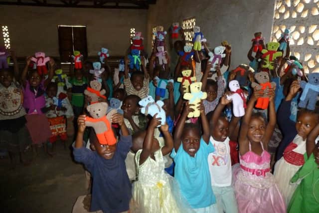 The children at Chitiwiri School in Salima, Malawi, with the teddy bears knitted by a blind club in Mountfield. Photo by Sally Bickersteth SUS-160612-142334001