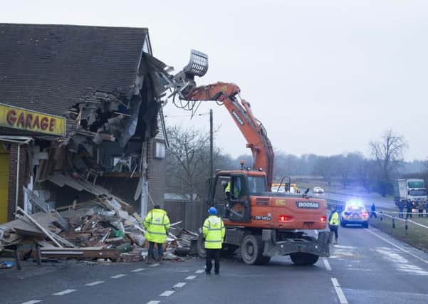 Machinery was used to pull apart the showroom after fears it would collapse. Pictures Eddie Mitchell
