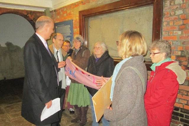Transport Secretary Chris Grayling and Chichester MP Andrew Tyrie (left) were met by protesters outside the Chichester Conservative Association dinner last week