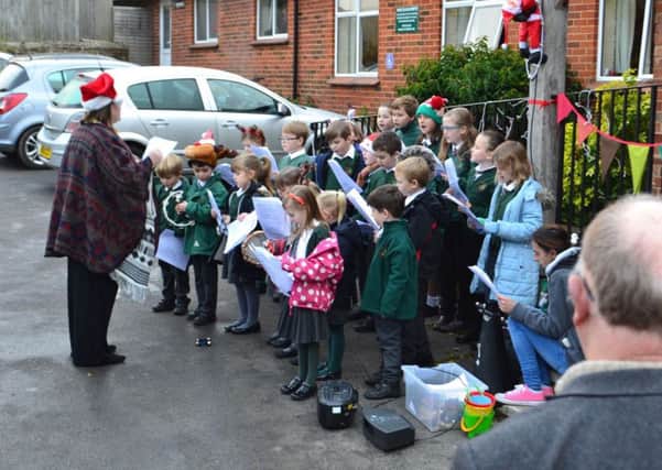 The new head conducts the school choir at Rogate's Christmas Market