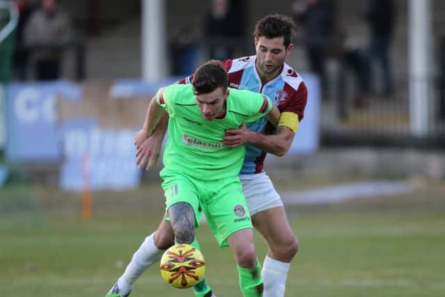 Ollie Rowe tussles for possession against Dorking Wanderers. Picture courtesy Scott White
