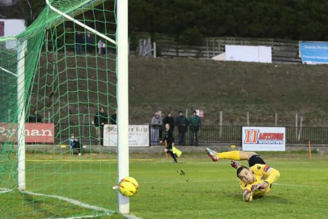 Dorking Wanderers goalkeeper Slavomir Huk looks on as a Frannie Collin shot flashes past the post. Picture courtesy Scott White