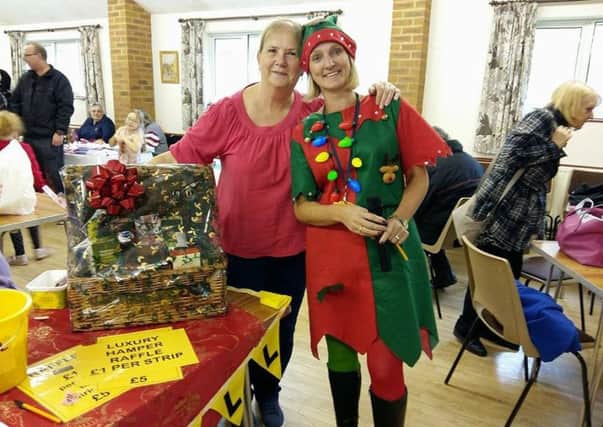 Homecall Volunteer Jenny Jones (left) winner of a  luxury Christmas hamper and Homecall Scheme Manager Leah Norman SUS-161213-134140001