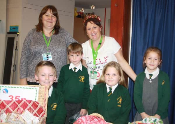 PTA Chair Michelle Hobson (rear right) with PTA member Catherine, and helpers Harrison, Raefe, Amie and Poppy at Little Common School's Magical Christmas Bazaar SUS-161213-140223001
