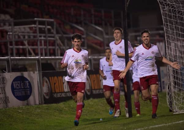 Worthing players celebrate after sealing a spot in the second-round of this year's FA Trophy on Saturday. Picture: Marcus Hoare