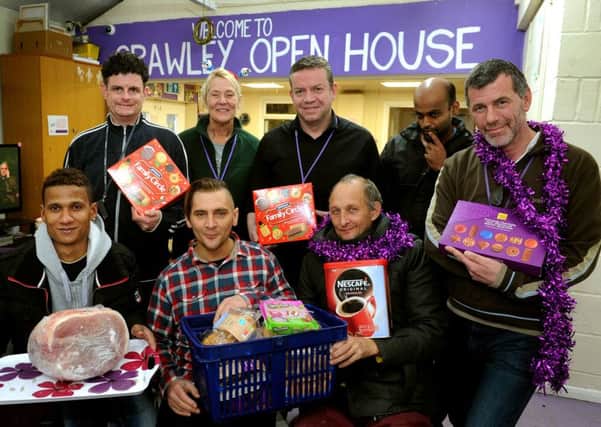 Chris Oxlade (centre, back row) with colleagues and clients at Crawley Open House with some of the donations