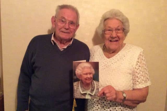 Stanley and Elizabeth Kentell with the congratulation card from Her Majesty the Queen on the occasion of  their Diamond Wedding December 8, 2016 SUS-161214-085744001