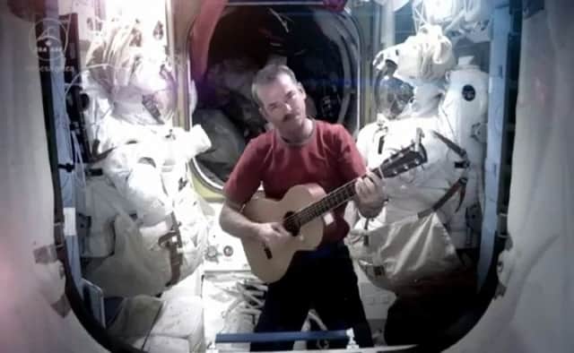 Chris Hadfield on the International Space Station making a cover version of David Bowie's Space Oddity (Photograph: YouTube)