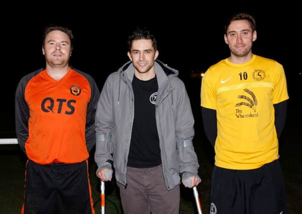 Midhurst's Matt Mason with just two of the many who turned out for a fundraising match / Picture by Clive Bennett