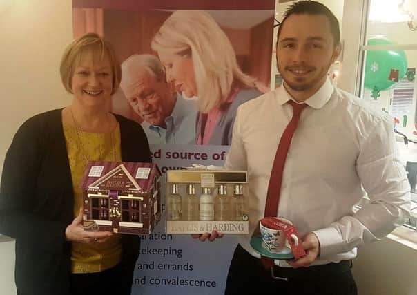 Alison Scutt and Care Manager Steve Hilliard with some of the donated gifts for the  Be a Santa to a Senior' gift giving scheme SUS-161221-100533001