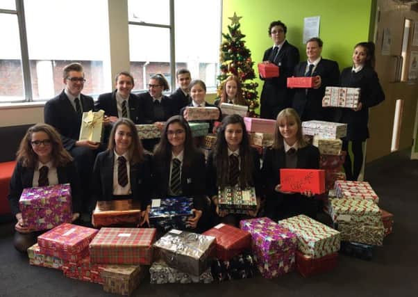 Students from Hailsham Community College with some of the 116 gifts for the Love in a Box appeal SUS-161221-085950001