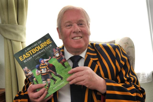 John Feakins with the book he has written about the history of Eastbourne Rugby Club