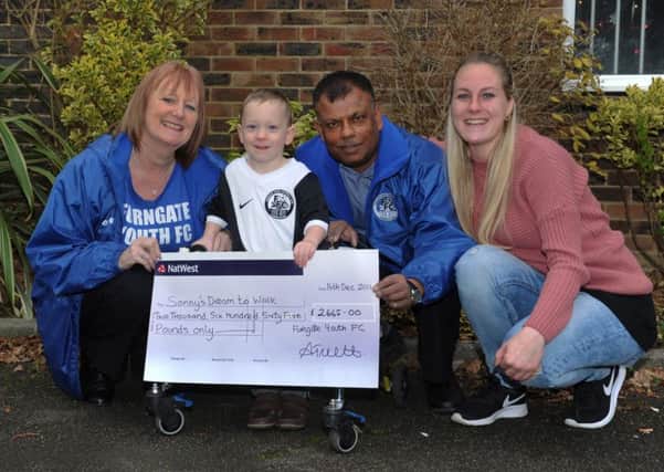 Furngate Youth Football Club's Anne Truett and Raj Dhiman present Sonny (2) and Katie with a cheque for ?2665-00 which Furngate Youth FC have raised (Photo by Jon Rigby) SUS-161220-122850001
