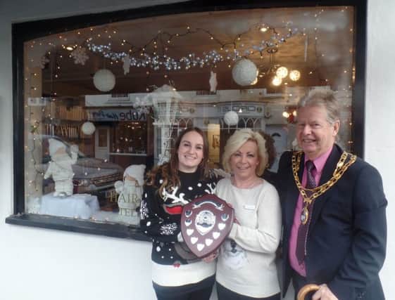 Hailsham Mayor Cllr Nigel Coltman presents the award to Abby Melluish and Fiona Marden at Legends